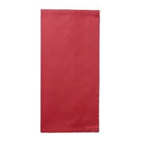 Red, pink, and orange garments hang side by side o