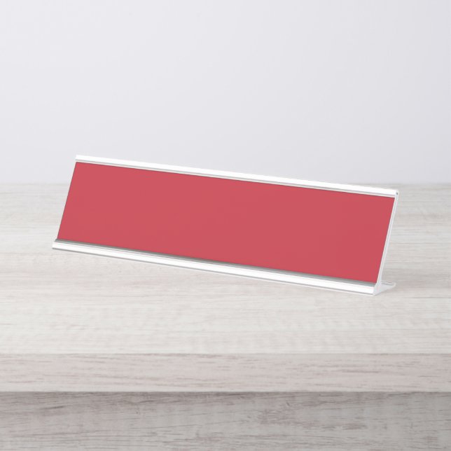 Red, pink, and orange garments hang side by side o desk name plate (Front)