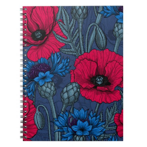 Red poppies and blue cornflowers on blue notebook