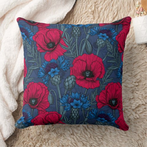 Red poppies and blue cornflowers on blue throw pillow