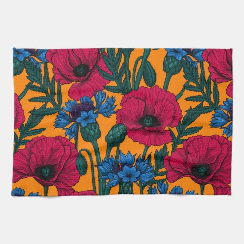 Red poppies and blue cornflowers on orange kitchen towel
