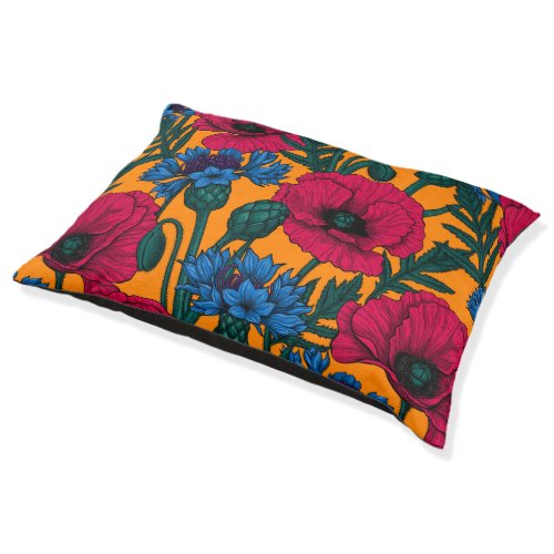 Red poppies and blue cornflowers on orange pet bed