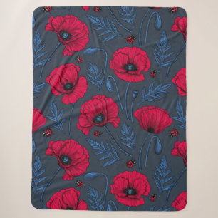 Red poppies and ladybugs on dark blue sherpa blanket