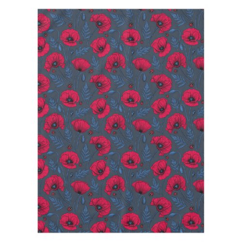 Red poppies and ladybugs on dark blue tablecloth