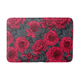 Red roses with gray leaves on black bath mat