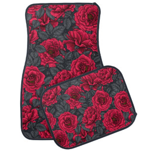 Red roses with gray leaves on black car floor mat