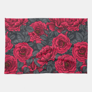 Red roses with gray leaves on black kitchen towel