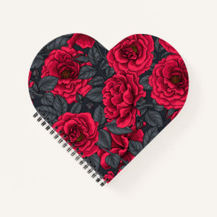 Red roses with gray leaves on black notebook