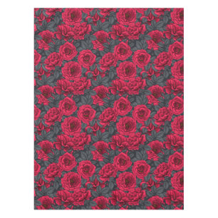 Red roses with gray leaves on black tablecloth