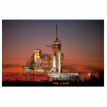 Red Sky for Space Shuttle Atlantis Launch Cutout<br><div class="desc">The crisp morning air was electric with anticipation as the first rays of dawn painted the sky a fiery red. The colossal white silhouette of the Space Shuttle Atlantis dominated the launchpad, dwarfed only by the immensity of the moment. A collective gasp rippled through the crowd as plumes of fire...</div>