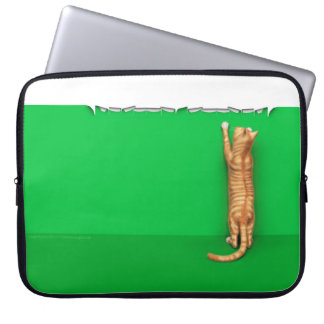 Red tabby cat rips paper laptop sleeve