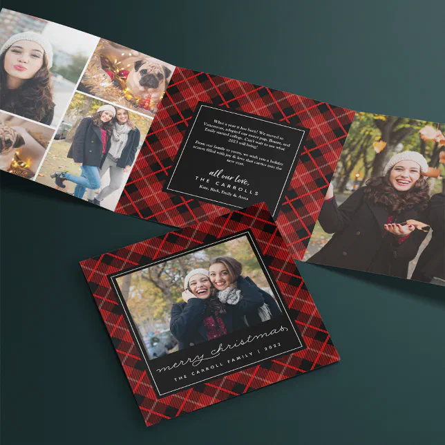 A red and black tri-fold card is seen set against a dark green background.