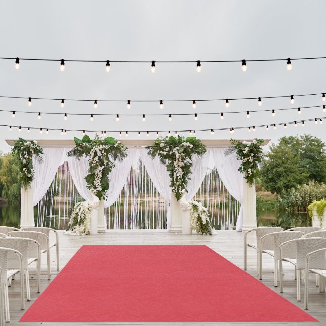 Red textured surface with subtle swirling pattern outdoor rug (Insitu (Wedding 1))