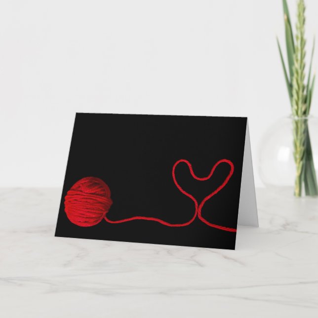 red yarn heart on black card (Front)
