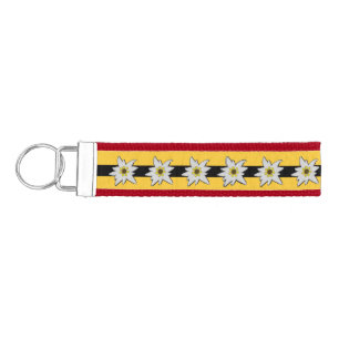 Red, Yellow and Black with White Edelweiss Flowers Wrist Keychain