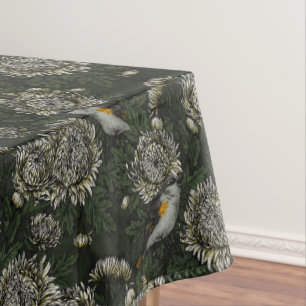 Redstarts in the chrysanthemums in green and white tablecloth