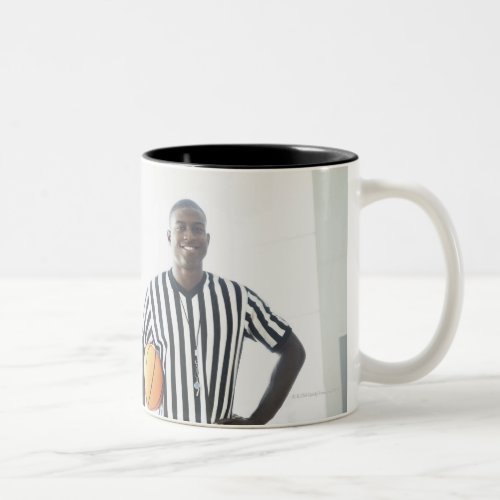 Referee holding basketball on court Two_Tone coffee mug