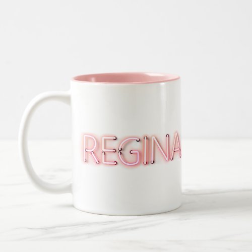 Regina name in glowing neon lights novelty Two_Tone coffee mug