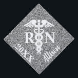 Registered Nurse Caduceus Silver Glitter Monogram Graduation Cap Topper<br><div class="desc">Registered Nurse Caduceus Silver Glitter Monogram Graduation Cap Topper Designed with silver faux glitter sparkle background and a large white medical caduceus symbol on the center. "RN" is in bold white block lettering on the sides of caduceus. Personalized with name in calligraphy script lettering on right diagonal area and custom...</div>