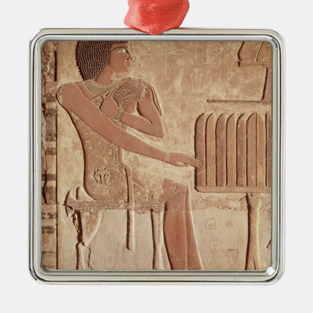 Relief depicting the deceased seated metal ornament (Front)