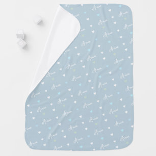 Repeating name and lines of small hearts on a blue baby blanket
