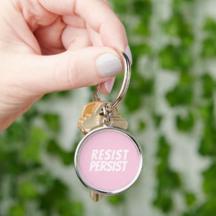 "resist persist" light pink white keychain