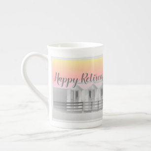 Retirement cup with seaside beach huts at sunset