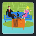 Retro Couple with Cat Acrylic Wall Clock<br><div class="desc">This Retro Couple with Cat Acrylic Wall Clock features a cartoon couple trying to get cozy while watching television on a mid century modern, blue sofa. The cat, however, has other ideas. On one side of the sofa, there is a handsome man in a black suit with red tie. On...</div>