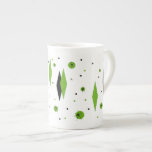 Retro Green Diamonds & Starbursts Bone China Mug<br><div class="desc">This customizable Retro Green Diamonds and Starbursts Bone China Mug is a new take on a vintage style. It features kitschy, black starbursts on green polka dots, surrounding geometric, green and black diamond shapes. Customize the background color on this mid century modern product if you're feeling daring, or leave it...</div>