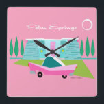 Retro Pink Palm Springs Acrylic Wall Clock<br><div class="desc">Between the pink background, turquoise mid century modern home, and the classic 1950s car, this design couldn’t be more Palm Springs if it said it in the clouds. Oh, wait, it does say it in the clouds! The blue and teal stone of the house is offset by the sputnik light...</div>