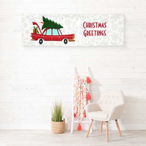 Retro Red Car Carrying a Christmas Tree Banner