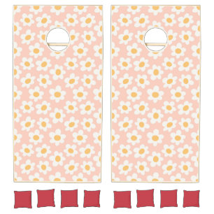 Retro style daisies in bloom on pink background cornhole set