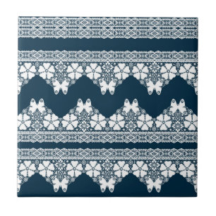 Retro white lace with butterflies on a dark blue b ceramic tile