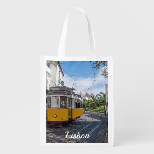 Retro yellow tram on street in Lisbon Portugal Grocery Bag