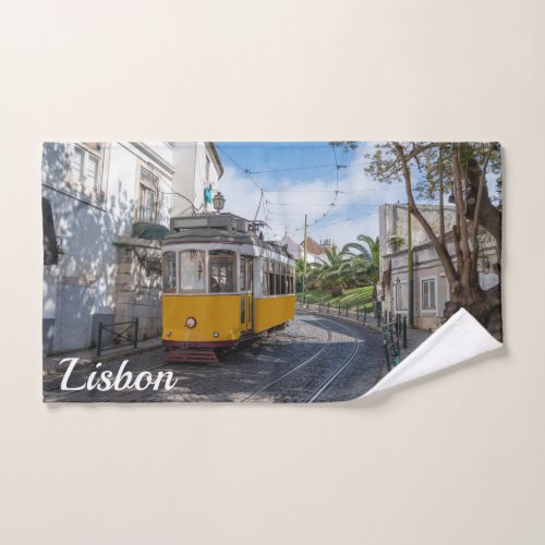 Retro yellow tram on street in Lisbon Portugal Hand Towel
