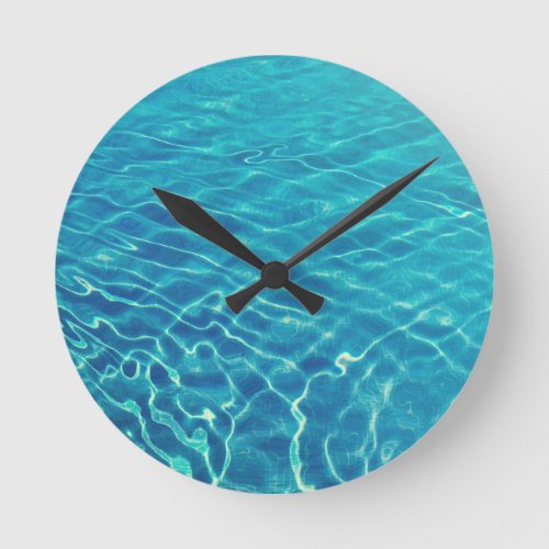 Ripples and wave patterns on crystal clear water round clock