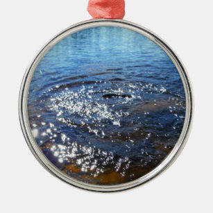 Ripples in a lake, from a fish jumping metal ornament