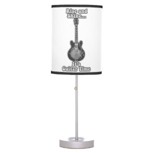 Rise and shine. it's guitar time. black and white table lamp