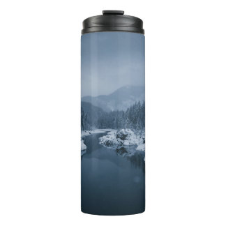 RIVER SURROUNDED BY SNOW COVERED FIELD WITH PINE T THERMAL TUMBLER