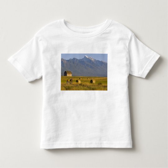 Road bicyclists race down back country road in toddler t-shirt