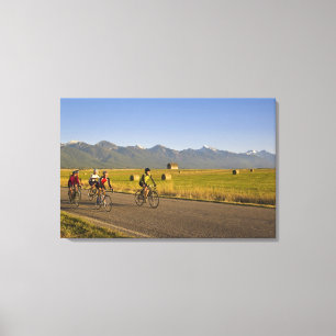 Road bicyclists ride down a back country road canvas print