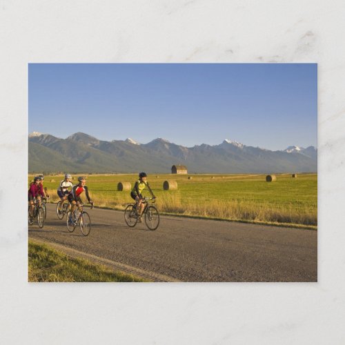 Road bicyclists ride down a back country road postcard