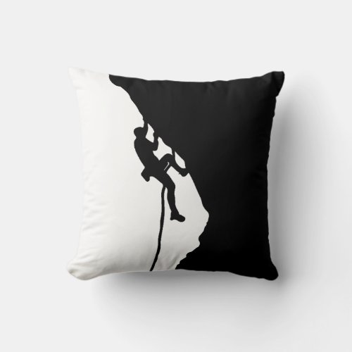 Rock climber conquers a sheer cliff  throw pillow