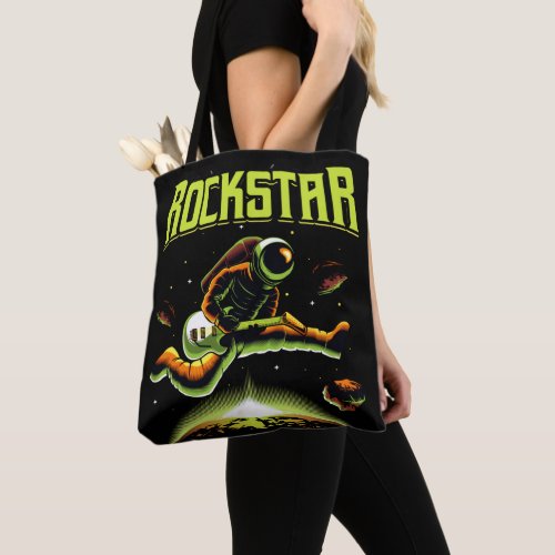 Rockstar astronaut playing guitar in space tote bag