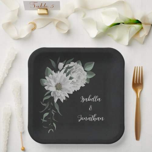 romantic white flowers  green leaves black paper plates