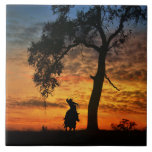 Roping Cowboy with Horse Country Western Ceramic Tile<br><div class="desc">Southwestern colored sunset with a huge oak tree this country western tile has a cowboy after that last stubborn steer before night fall.</div>
