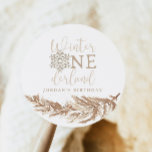 RORY Boho Beige Winter Wonderland First Birthday Classic Round Sticker<br><div class="desc">The Rory Collection features a boho beige coloring with gold glitter snowflakes, cream fern branches and a rustic font combination. This first birthday themed collection is the perfect bohemian gender neutral celebration for your little one. Pair these items with anything in the Rory Beige Collection for a cohesive look: https://www.zazzle.com/collections/rory_boho_beige_winter_wonderland_first_birthday-119740971188523979...</div>