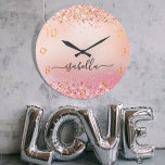 Rose gold blush pink glitter dust name script large clock<br><div class="desc">A rose gold and blush pink gradient background, decorated with faux glitter dust. Golden numbers. Personalize and add a name. The name is written with a modern hand lettered style script with swashes. To keep the swashes only delete the sample name, leave the spaces or emoji's in front and after...</div>