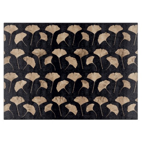 Rose gold ginko leaves black background cutting board