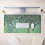 Rosebushes Under The Trees, Gustav Klimt Desk Mat<br><div class="desc">Gustav Klimt (July 14, 1862 – February 6, 1918) was an Austrian symbolist painter and one of the most prominent members of the Vienna Secession movement. Klimt is noted for his paintings, murals, sketches, and other objets d'art. In addition to his figurative works, which include allegories and portraits, he painted...</div>